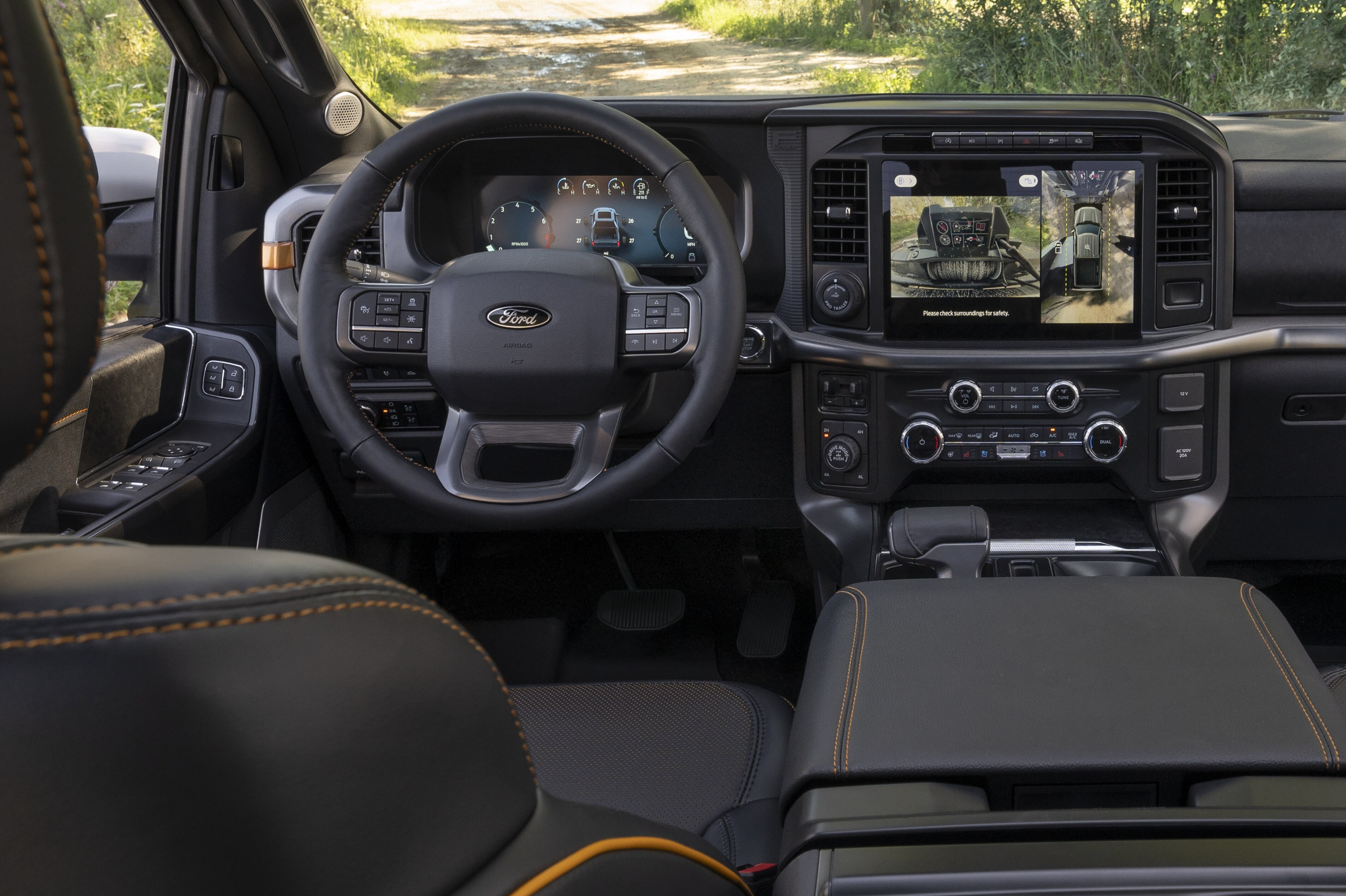 Interior of a 2024 Ford F-150 TREMOR pickup showing the front dash, steering wheel and 12-inch display screen near me in Port Arthur, TX